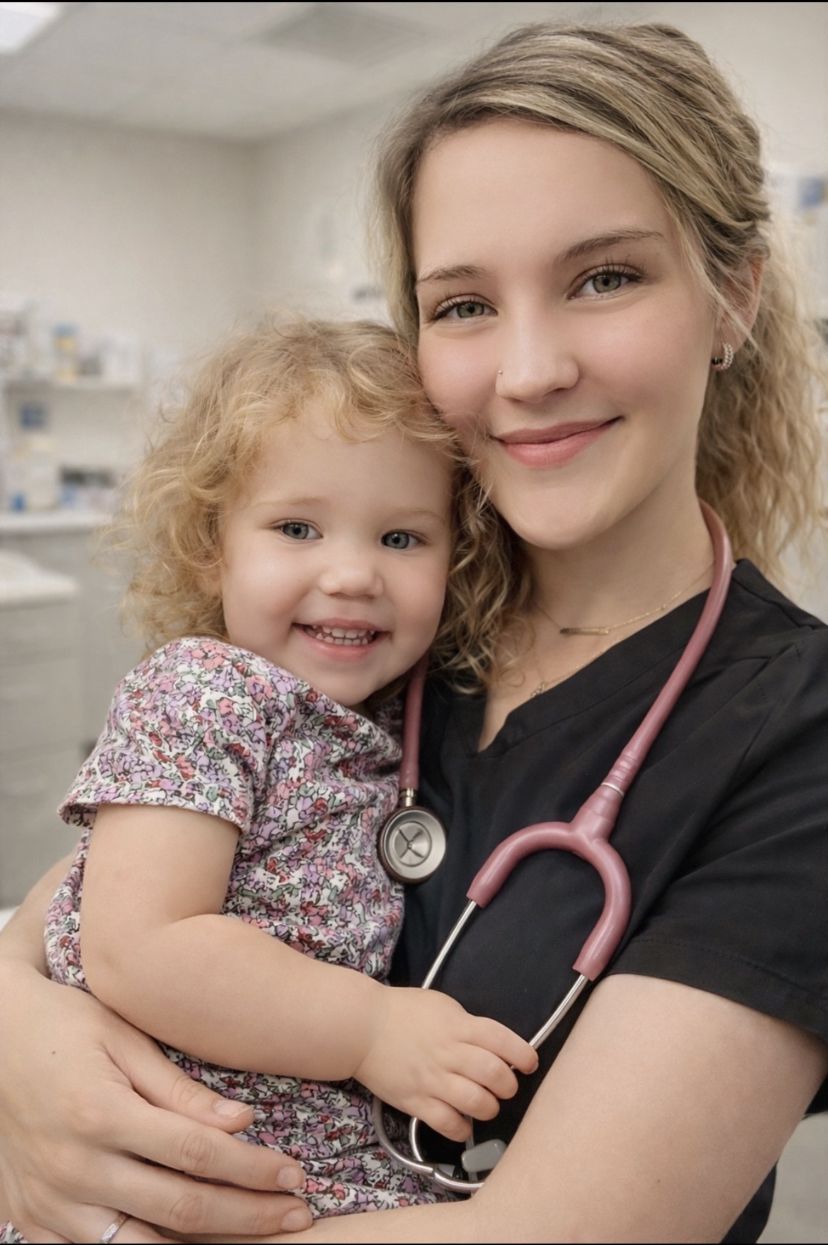 Ashley smiling while holding a young child