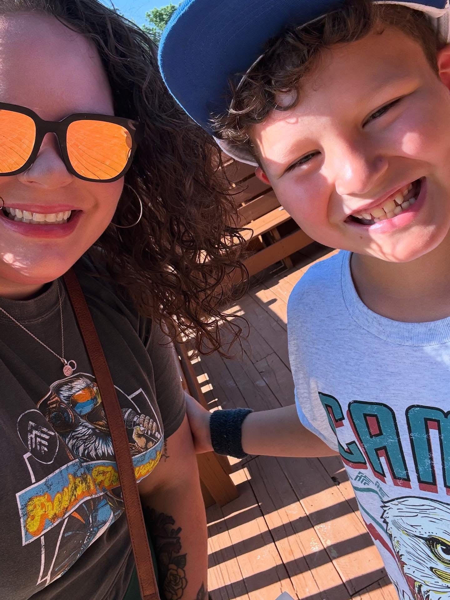 Anna smiling outdoors with her son